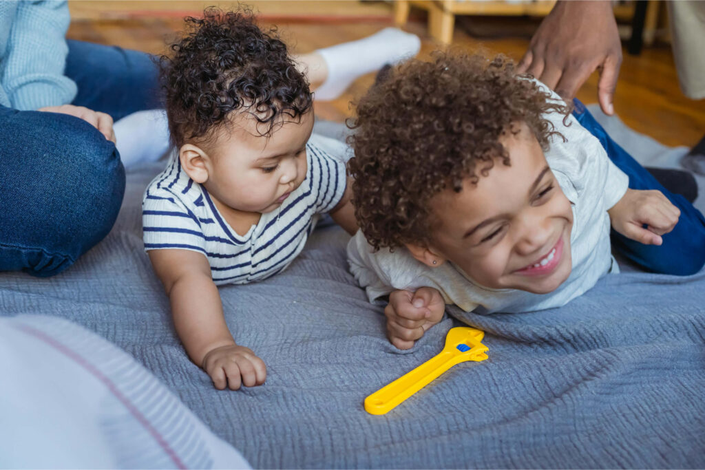 Two young black brothers playing at home
