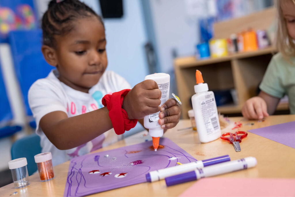 Black preschool girl making crafts
